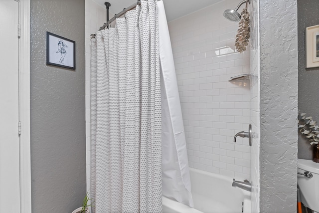 bathroom with toilet and shower / tub combo