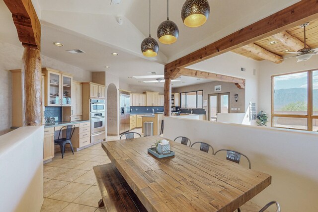 tiled dining space featuring ceiling fan, wood ceiling, and vaulted ceiling