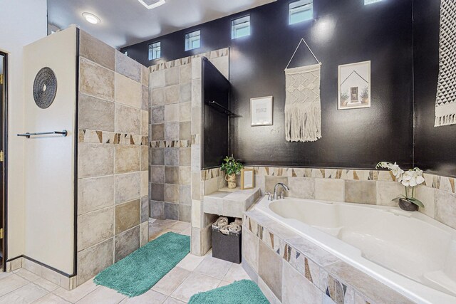 bathroom with tile patterned floors and independent shower and bath