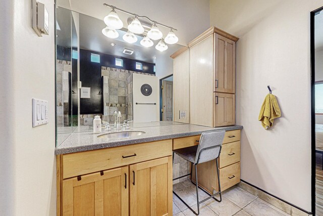 bathroom with tile patterned floors and vanity