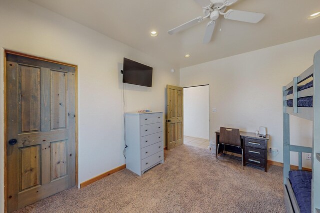 carpeted office space featuring ceiling fan