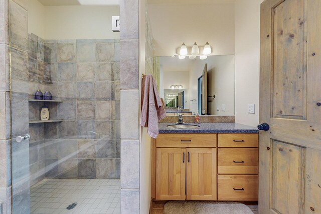 bathroom with vanity and a tile shower