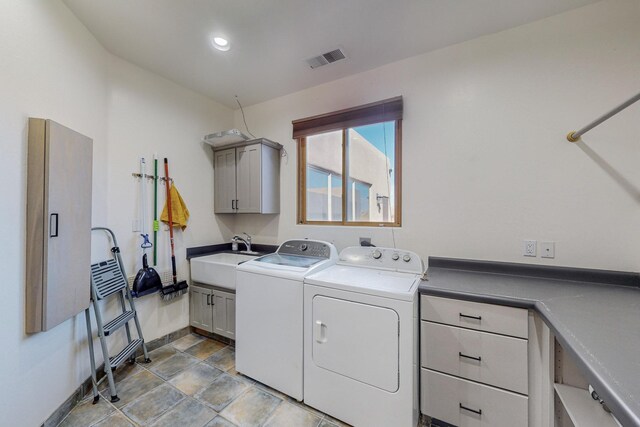 clothes washing area with cabinets, independent washer and dryer, and sink