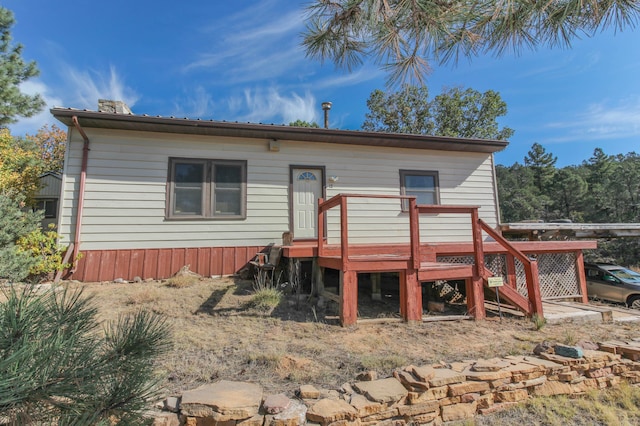 rear view of house with a wooden deck