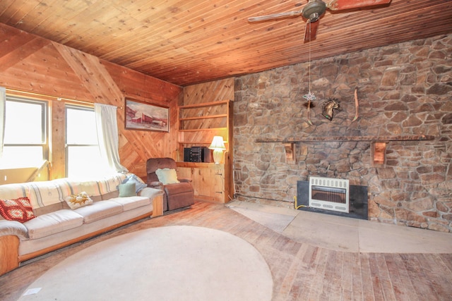 unfurnished living room with wood walls, wood-type flooring, heating unit, wooden ceiling, and vaulted ceiling