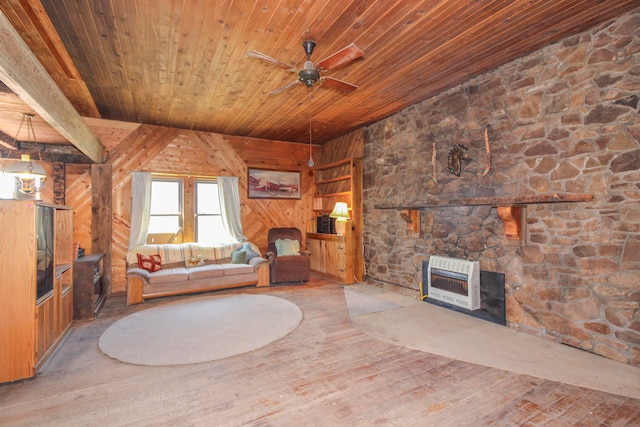 unfurnished living room featuring a stone fireplace, heating unit, wooden walls, wooden ceiling, and hardwood / wood-style floors