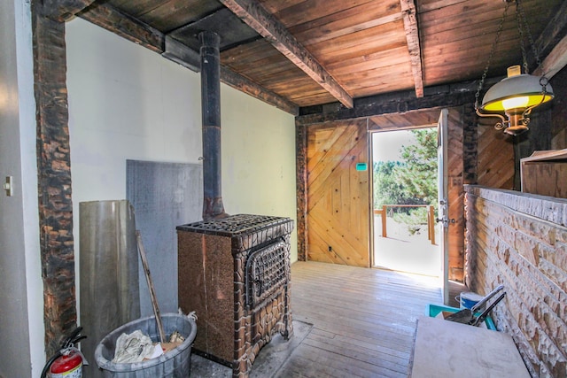 living room featuring wood-type flooring, wooden walls, wood ceiling, and beam ceiling