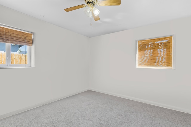 unfurnished room with ceiling fan and carpet flooring