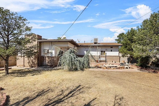 rear view of property featuring central AC