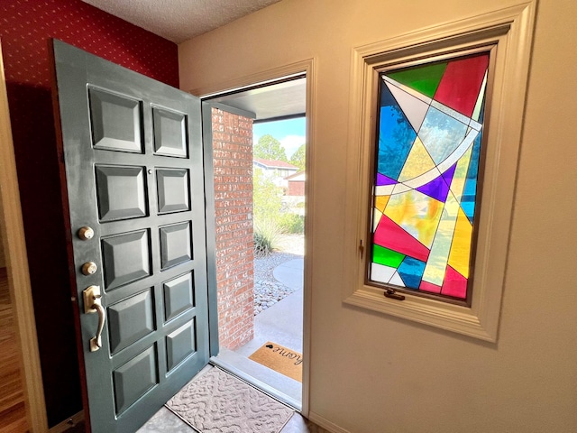 entrance foyer featuring a textured ceiling