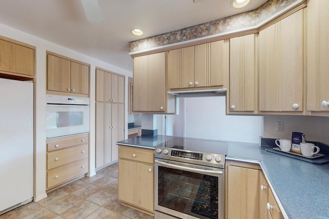 kitchen featuring light brown cabinets, light tile patterned floors, and white appliances