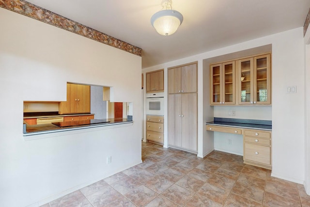 kitchen with built in desk and white appliances