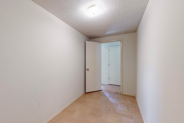 corridor with a textured ceiling