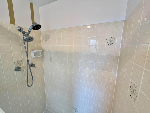 bathroom with a tile shower