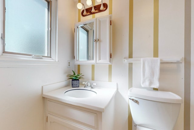 bathroom featuring toilet and vanity