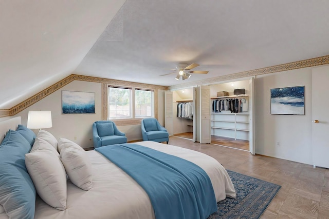 bedroom featuring ceiling fan, light parquet flooring, and lofted ceiling