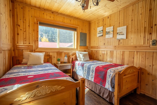 bedroom featuring dark hardwood / wood-style flooring and wooden walls