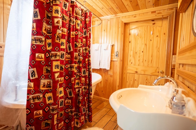 bathroom featuring wood ceiling, wood walls, sink, and hardwood / wood-style floors