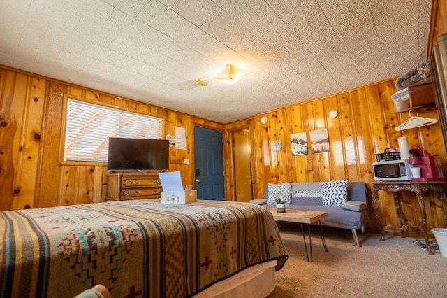 bedroom with wooden walls and carpet flooring