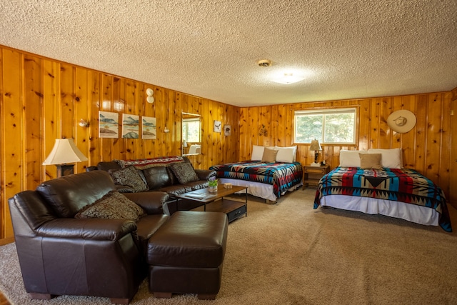 carpeted bedroom featuring a textured ceiling and wood walls