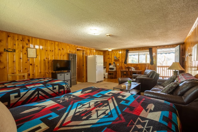 living room with a textured ceiling and wooden walls