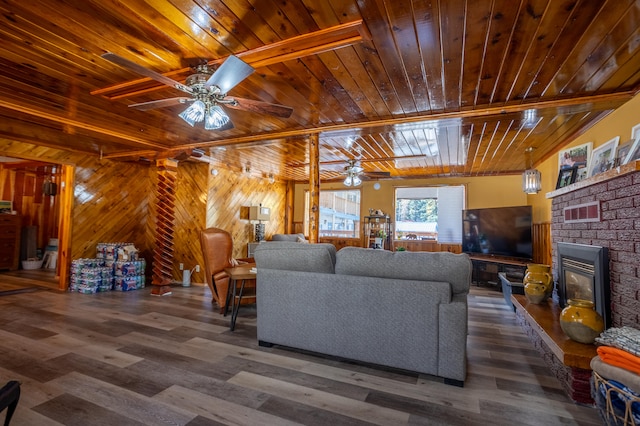 living room featuring ceiling fan, wooden walls, wooden ceiling, and dark hardwood / wood-style flooring