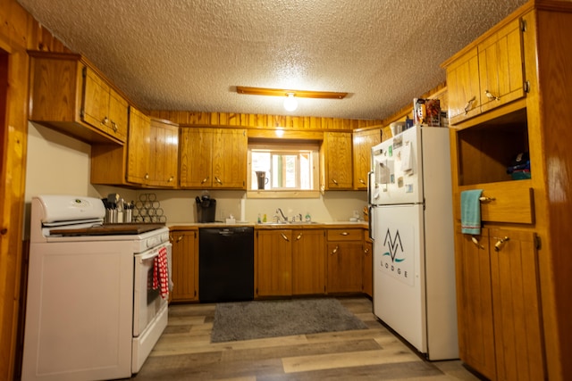 kitchen with light hardwood / wood-style flooring, a textured ceiling, sink, and white appliances