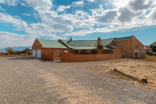 exterior space with a garage and a mountain view