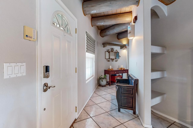 entryway featuring beam ceiling, wooden ceiling, and light tile patterned flooring