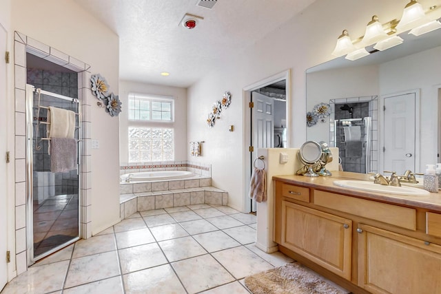 bathroom with vanity, plus walk in shower, a textured ceiling, and tile patterned floors