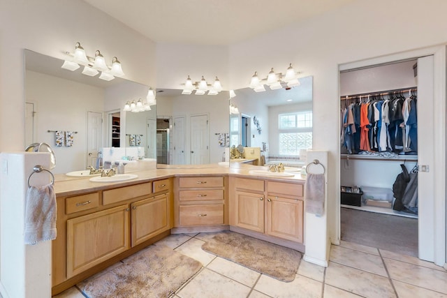 bathroom featuring vanity, tile patterned floors, and a shower with shower door