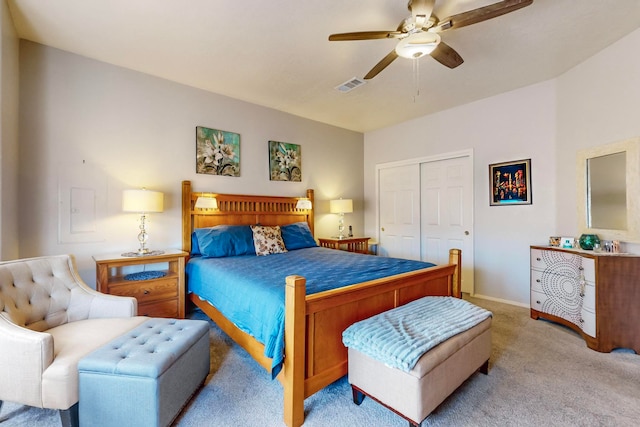 bedroom with light carpet, a closet, and ceiling fan