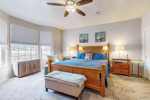 bedroom featuring light carpet and ceiling fan