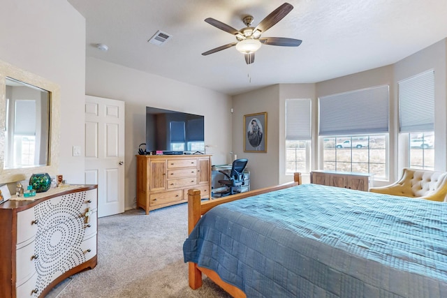 bedroom featuring light carpet and ceiling fan