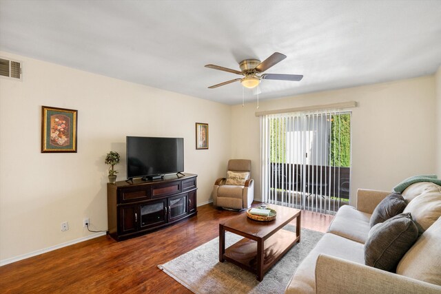 living room featuring ceiling fan and dark hardwood / wood-style floors