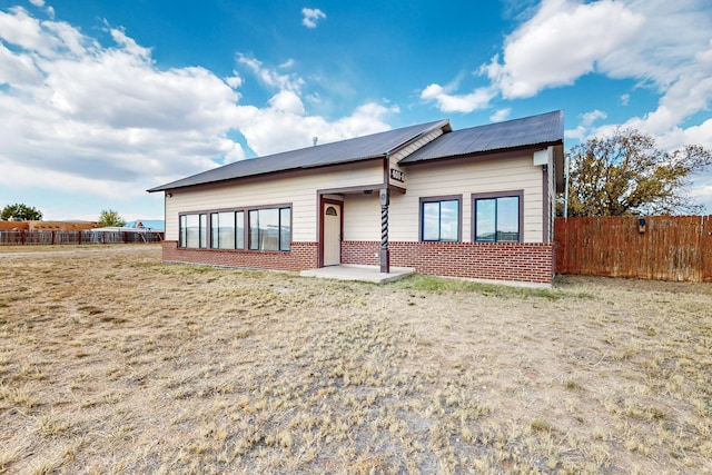 401A Nm-344, Edgewood, NM 87015 - view of front of home with brick siding, fence, and metal roof