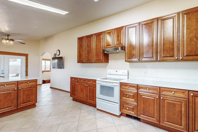 401A Nm-344, Edgewood, NM 87015 - kitchen featuring light countertops, a ceiling fan, white electric stove, under cabinet range hood, and brown cabinetry