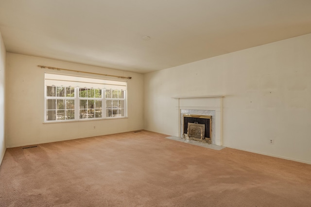 unfurnished living room with light colored carpet