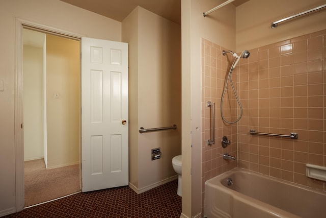 bathroom with toilet and tiled shower / bath combo