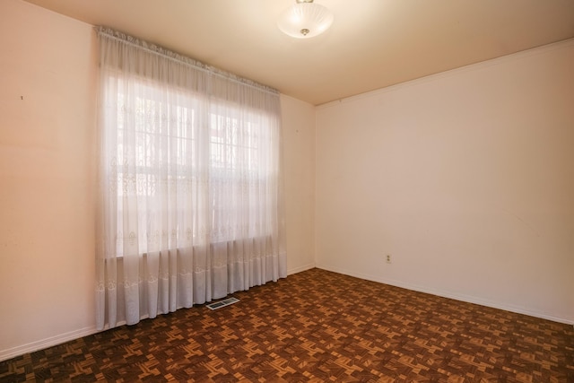 spare room with dark parquet floors