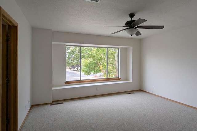 carpeted empty room featuring a textured ceiling and ceiling fan