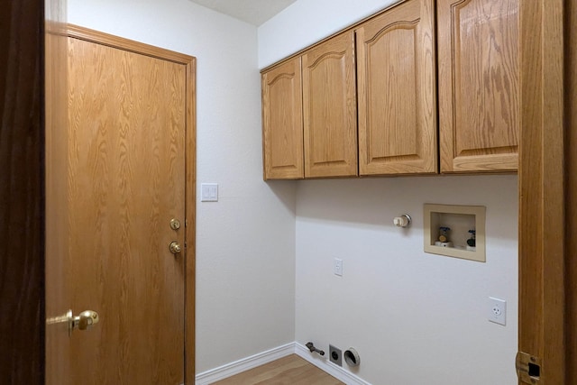 clothes washing area featuring washer hookup, gas dryer hookup, and cabinets