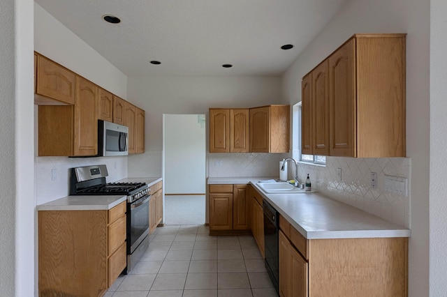 kitchen with light tile patterned floors, appliances with stainless steel finishes, sink, and decorative backsplash