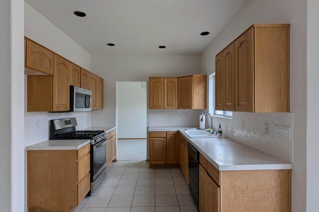 4508 Stockbridge Ave NW, Albuquerque, NM 87120 - kitchen featuring appliances with stainless steel finishes, a sink, tasteful backsplash, and light countertops