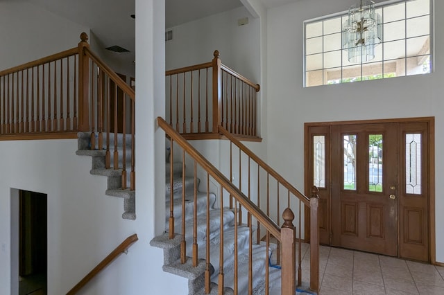4508 Stockbridge Ave NW, Albuquerque, NM 87120 - tiled entrance foyer featuring a chandelier, stairs, and a towering ceiling