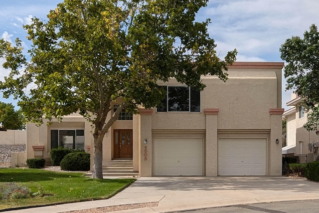 view of front of property featuring a garage and a front lawn