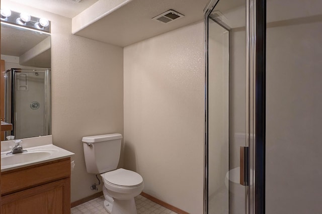 bathroom with a shower with door, vanity, and toilet