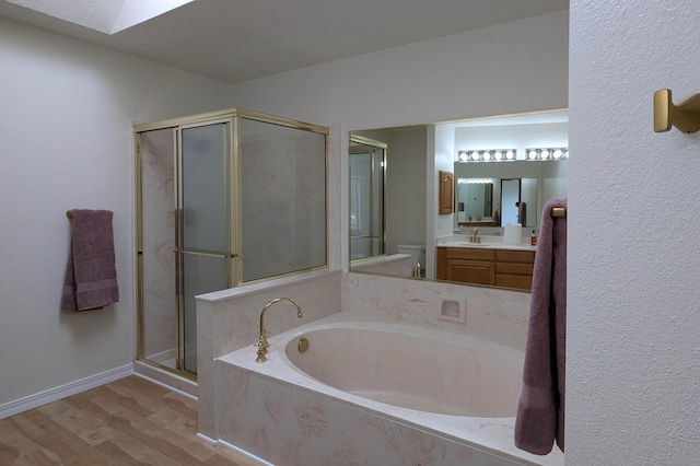 4508 Stockbridge Ave NW, Albuquerque, NM 87120 - bathroom featuring a garden tub, toilet, vanity, a shower stall, and wood finished floors