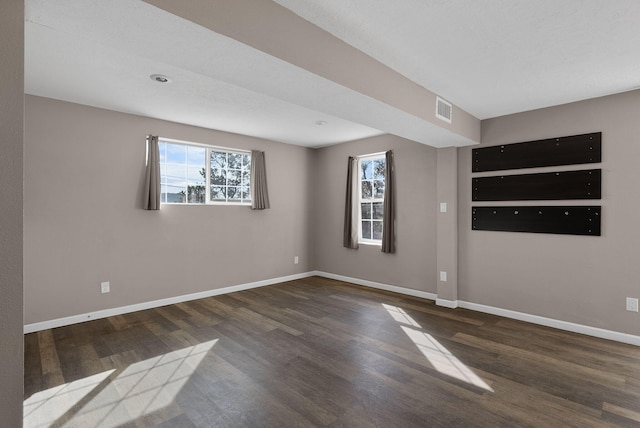 spare room with dark hardwood / wood-style floors