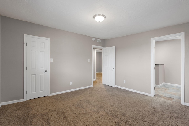 unfurnished bedroom with carpet floors and a closet